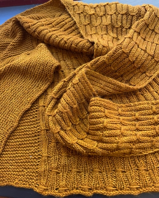 Hand-knitted garment in burnt orange