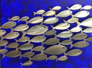 stainless steel fish on blue painted panel