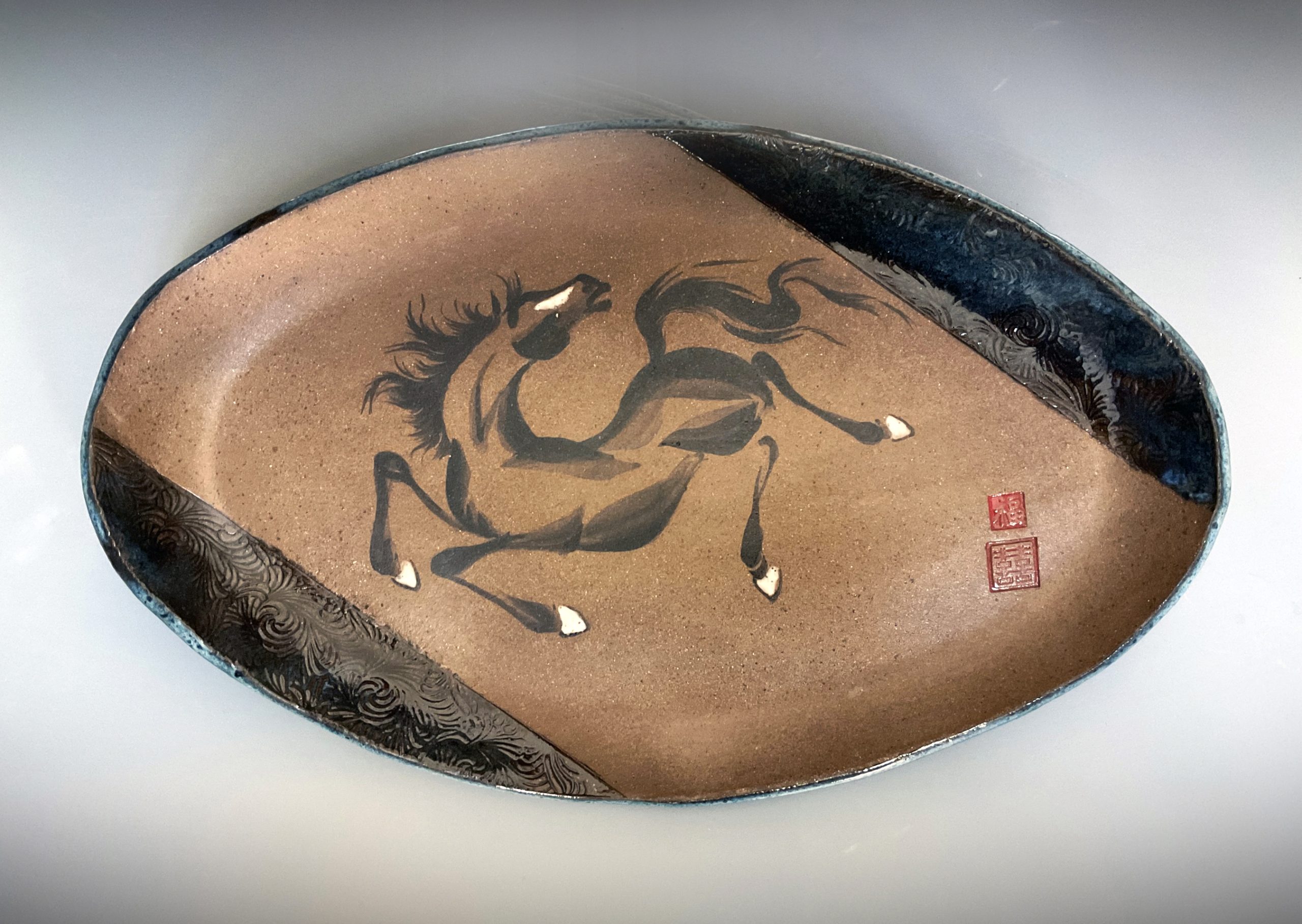 Oval platter of a painted horse
